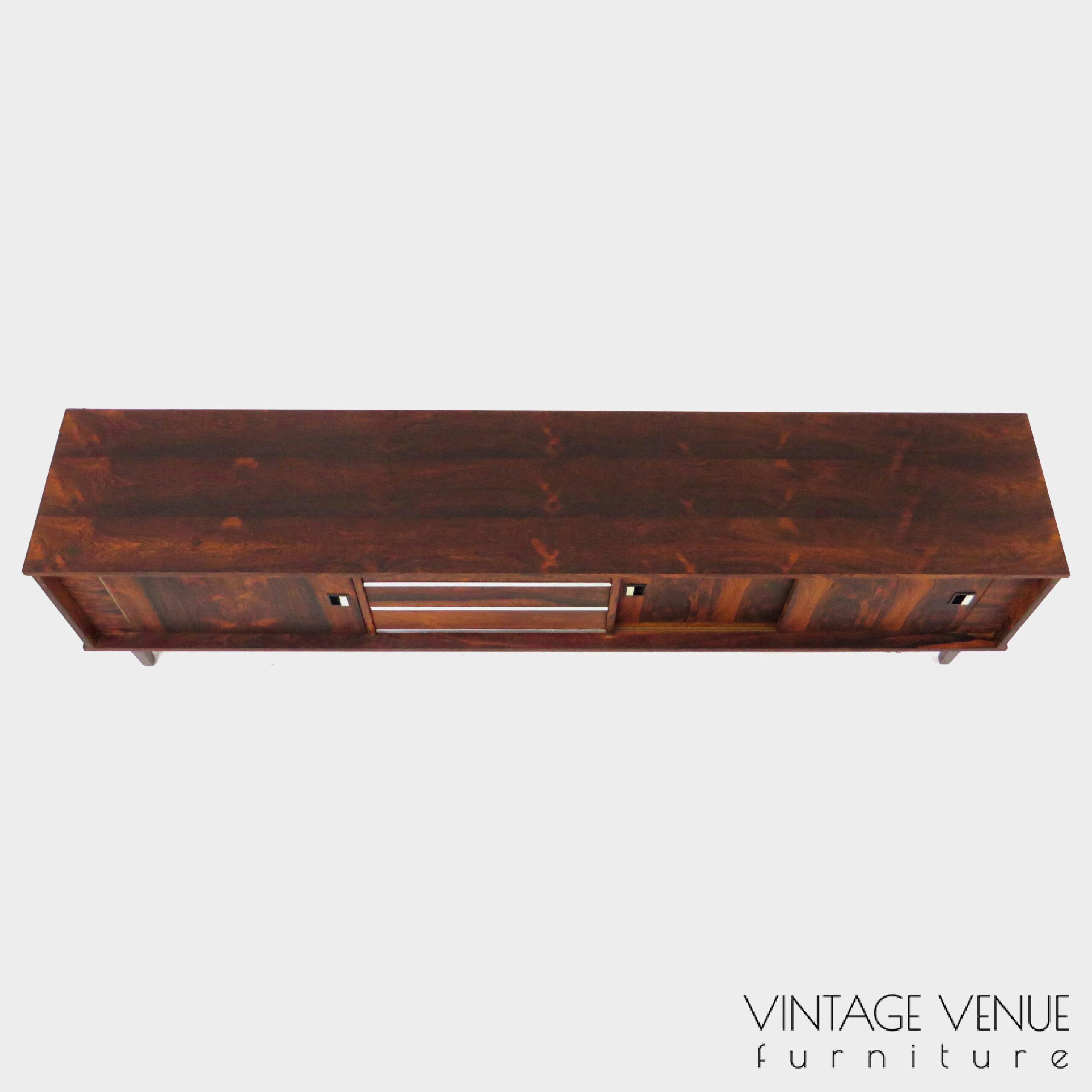 Vintage mid century modern low sideboard made of rosewood palisander, on 4 wooden legs with 2 sliding doors and 3 drawers with stylish handles & legs Period: 1960s Vintage retro lowboard dressoir tv-meubel van rosewood palissander met 2 schuifdeuren, 3 lades & stijlvolle handgrepen en pootjes, jaren 50 60 70