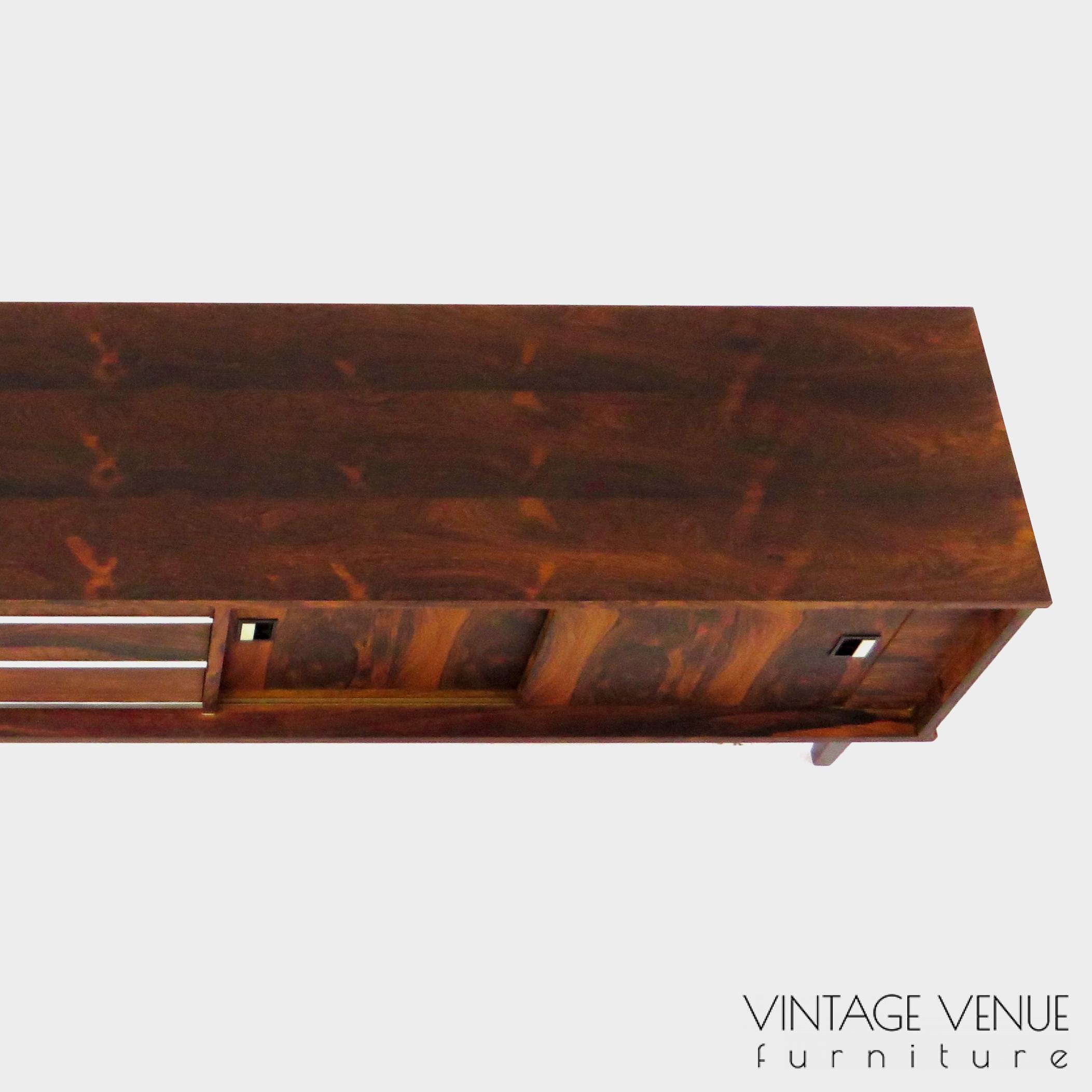 Vintage mid century modern low sideboard made of rosewood palisander, on 4 wooden legs with 2 sliding doors and 3 drawers with stylish handles & legs Period: 1960s Vintage retro lowboard dressoir tv-meubel van rosewood palissander met 2 schuifdeuren, 3 lades & stijlvolle handgrepen en pootjes, jaren 50 60 70