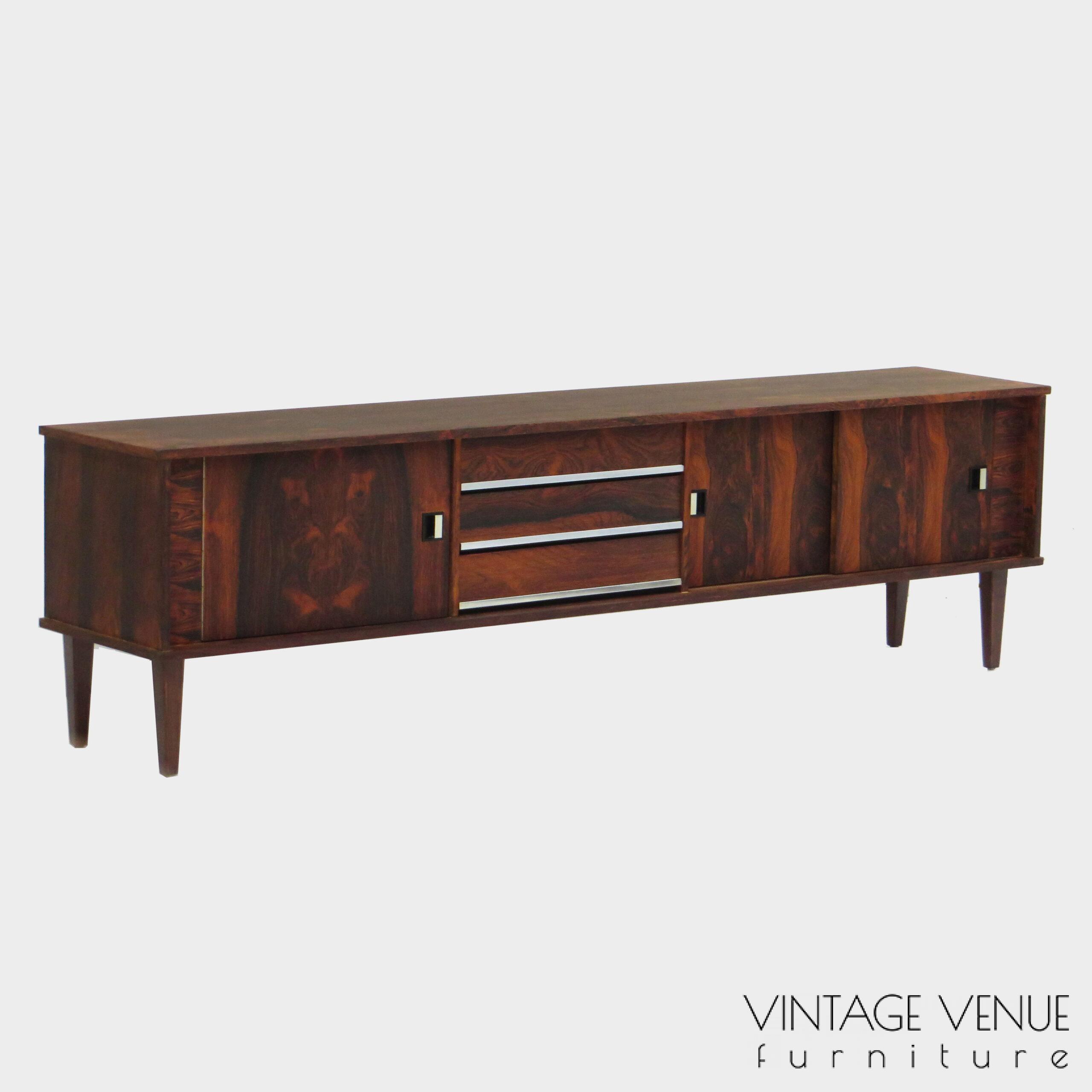 Vintage mid century modern low sideboard made of rosewood palisander, on 4 wooden legs with 2 sliding doors and 3 drawers with stylish handles & legs Period: 1960s Vintage retro lowboard dressoir tv-meubel van rosewood palissander met 2 schuifdeuren, 3 lades & stijlvolle handgrepen en pootjes, jaren 50 60 70